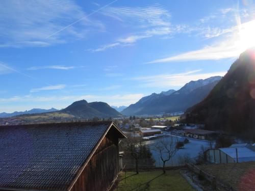 a view of a valley with mountains and a barn at Gästehaus Wolf in Pfronten