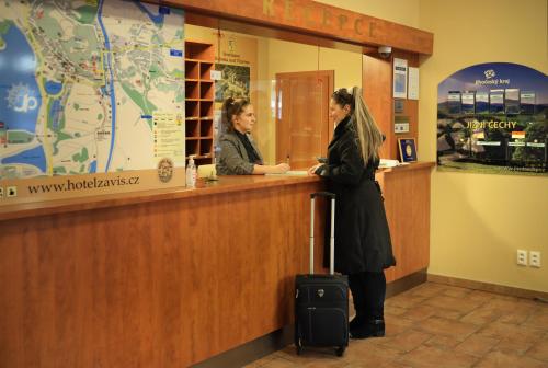 two women standing at a counter in a store at Záviš z Falkenštejna in Hluboká nad Vltavou