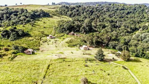 an aerial view of a farm on a hill with trees at AfriCamps at Gowan Valley in Balgowan