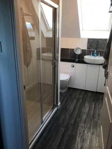 a bathroom with a shower and a toilet and a sink at Castle View - Home from Home in Stirling