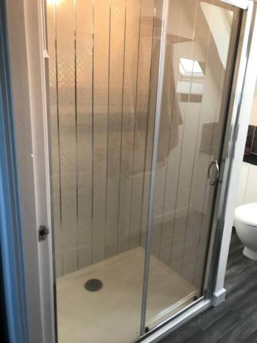 a shower with a glass door in a bathroom at Castle View - Home from Home in Stirling