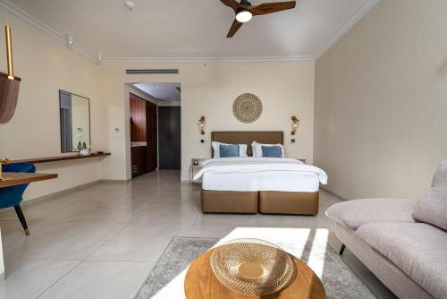 a bedroom with a bed and a living room at Amirey Hagalil Boutique Hotel in Amirim