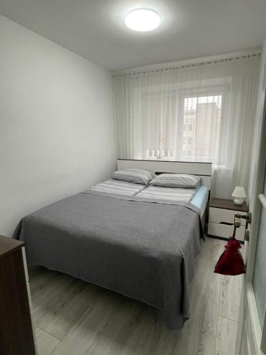A bed or beds in a room at Central Boulevard Apartment
