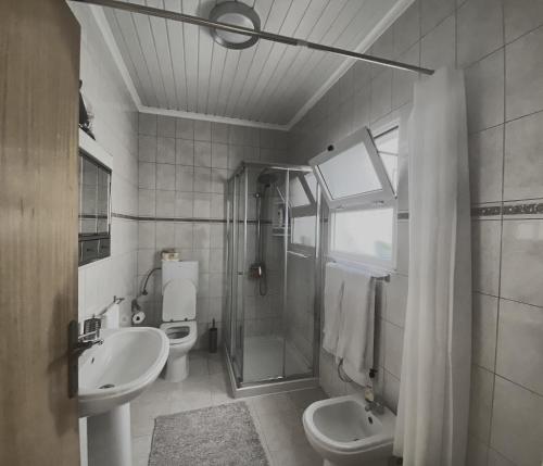 a bathroom with a sink and a toilet and a shower at Além do Mar Apartment - RRAL n. 3214 in Ribeira Grande