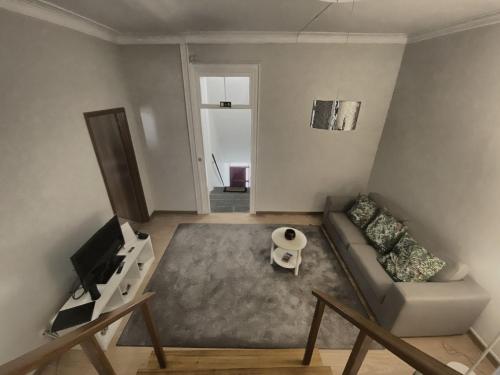 a living room with a couch and a tv at Além do Mar Apartment - RRAL n. 3214 in Ribeira Grande