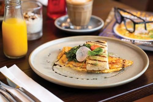 a plate of food with toast on a table at Rydges Wellington Airport in Wellington