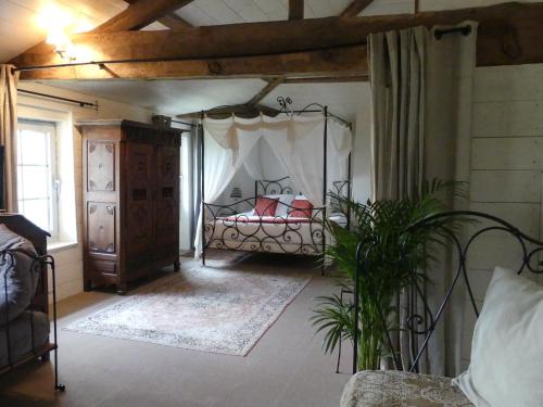a bedroom with a bed with a canopy at Domaine de l’Escuderia in Parentis-en-Born