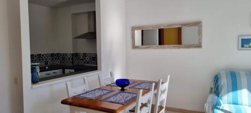 a dining room table with two chairs and a kitchen at Sa Shei Apartment Tossa de Mar in Tossa de Mar