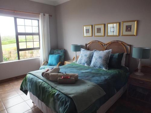 a bedroom with a bed with two teddy bears on it at Sieniesee in Mossel Bay