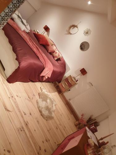 a bedroom with a bed and a wooden floor at La Mara Élo in Sart-lez-Spa