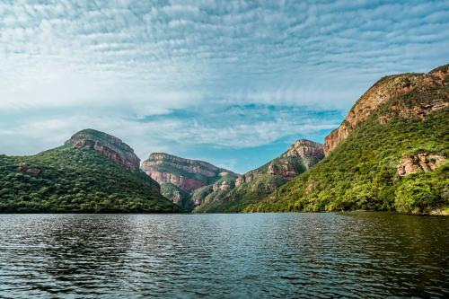 a view of a mountain from the water at AfriCamps at Mackers in Hazyview