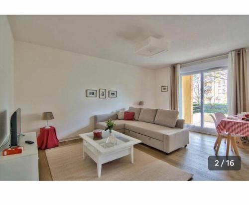 a living room with a couch and a table at Grand Noble - Blagnac in Blagnac