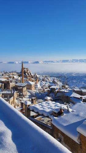 a view of a city covered in snow at Mak's Cave House in Uchisar