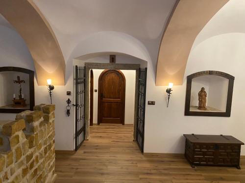 a hallway with arches and a door and a table at SUPERB - Medieval apartment in Kutná Hora