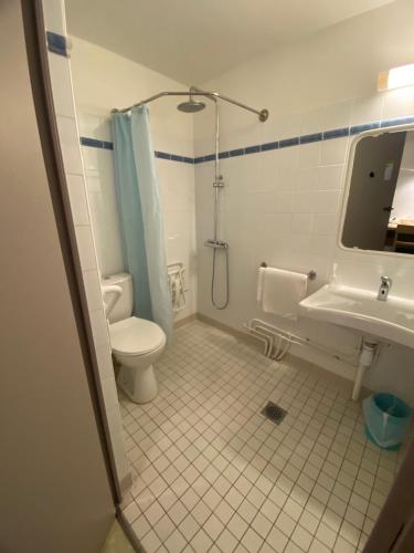 a bathroom with a toilet and a shower and a sink at HOTEL RESTAURANT OLYMPE in Aix-en-Provence