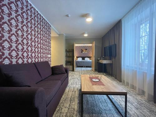 a living room with a couch and a table at von ROSEN spa in Mäetaguse