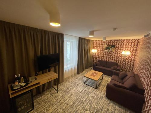a living room with a couch and a tv at von ROSEN spa in Mäetaguse