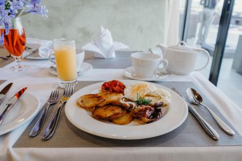 a plate of food on a table with a plate of food at Mantis Kivu Marina Bay Hotel in Muhari