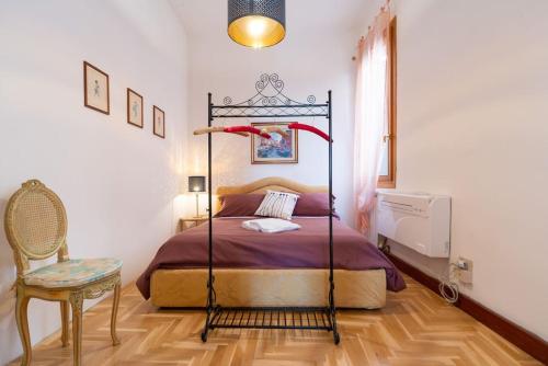 a bedroom with a bed and a chair in it at Ca' sull' Acqua in Venice