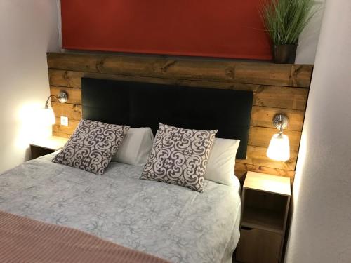 a bedroom with a bed with two pillows at APARTAMENTO EN CANFRANC ESTACION in Canfranc-Estación