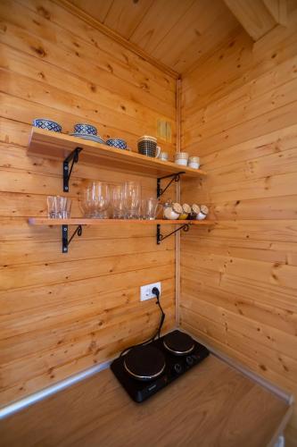 a stove in a wooden room with wooden walls at Brvnara Zlatiborka in Zlatibor
