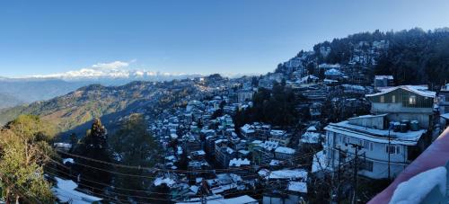 a view of a town on a mountain at The Silver Spring Homestay in Darjeeling