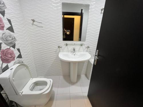 a bathroom with a toilet and a sink at Economic rooms for rent in Dubai in Dubai