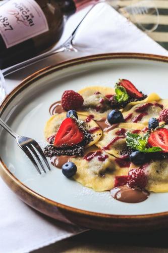 a plate of food with fruit and berries on it at Chateau Purcari in Purcari