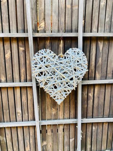 a white heart hanging on a wooden wall at Cottonwood Guesthouse Oasis in Bloemfontein