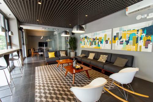 a living room with a couch and a table and chairs at Hotel Centro 433 in Sao Paulo