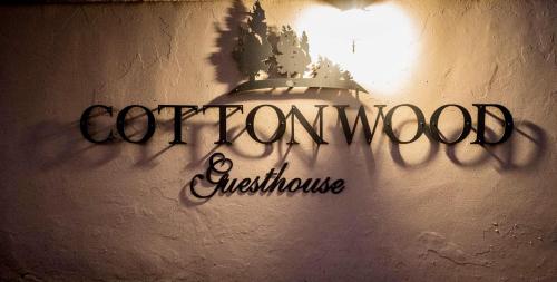 a sign on a wall with the words comfort woman and architecture at Cottonwood Guesthouse Oasis in Bloemfontein