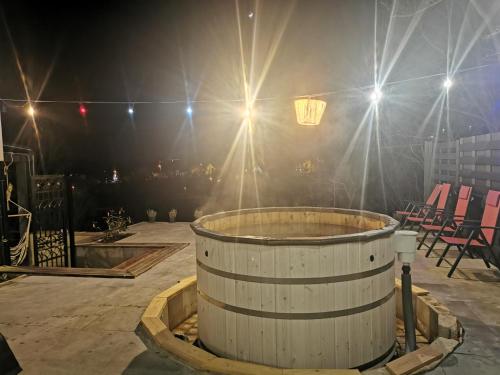 a large barrel in a room with chairs and lights at Illaberek Vendégház in Sukoró