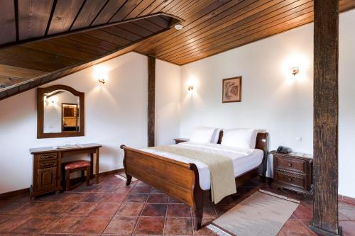 a bedroom with a bed and a wooden ceiling at Chateau Purcari in Purcari