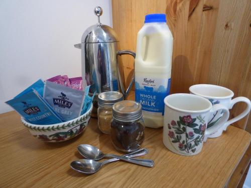 a counter with milk and other kitchen items on it at Highfield House, Parracombe, Modern B&B in Parracombe