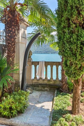 a water fountain in a garden with a view of the ocean at Villa Maria Boutique Hotel in Cannobio