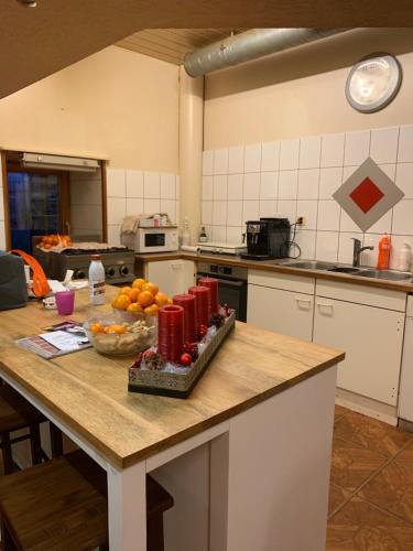 a kitchen with a table with a bowl of fruit on it at Chez Dodo 2534 Orvin Le Foncet in Evilard