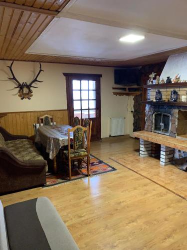a living room with a table and a fireplace at Подина in Vorokhta