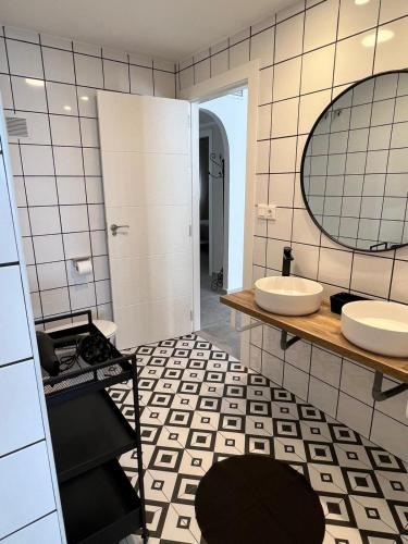 a bathroom with two sinks and a mirror at Apartamentos La Mar in Altea