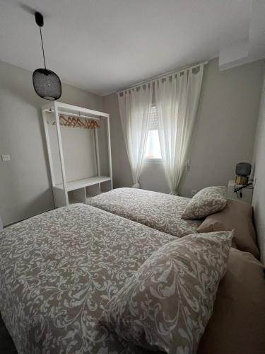 a bedroom with a bed and a window at Apartamentos La Mar in Altea
