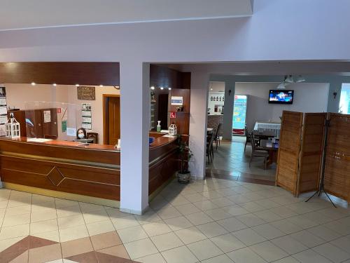 a lobby of a store with a counter and a restaurant at Hotel Dowhań in Nowe