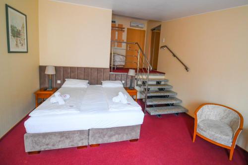 a bedroom with a bed and a spiral staircase at Pensjonat Fitness & Spa Gregor in Zielona Góra