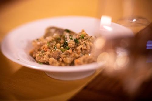 a white bowl of food on a table at B&B Villa Sumrak Plitvica in Plitvica selo