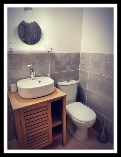 a bathroom with a sink and a toilet at La Belle D'Âme - Guest House in Prades