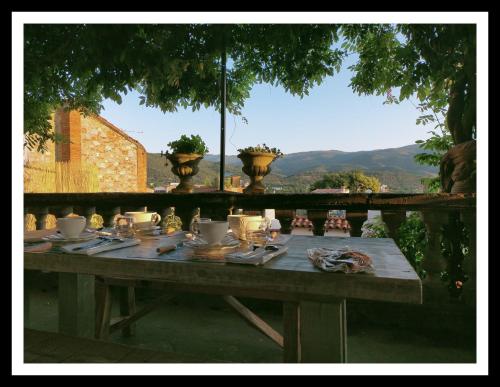a wooden table with plates and utensils on it at La Belle dAme in Prades