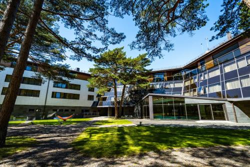 an university building with a tree in front of it at Gabija Hotel SPA & Conferences in Palanga