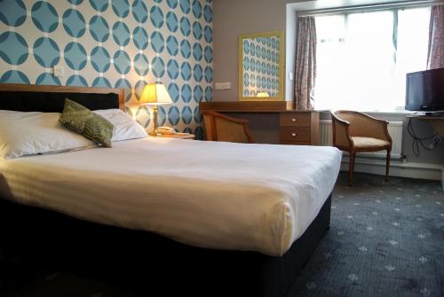 a hotel room with a large bed and a window at Suncliff Hotel - OCEANA COLLECTION in Bournemouth