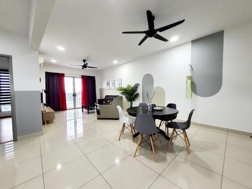 a dining room and living room with a ceiling fan at Residensi Flora in Seri Kembangan