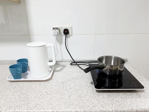 a kitchen counter with a pot on a stove at Residensi Flora in Seri Kembangan