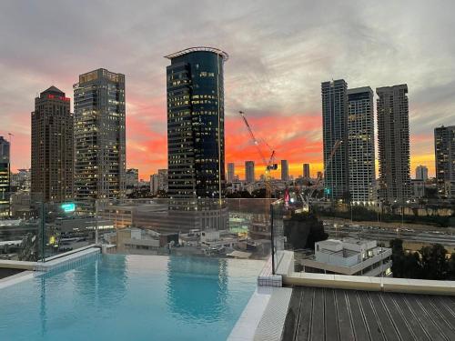 a view of a city skyline with a large swimming pool at Hotel Indigo Tel Aviv - Diamond District by IHG in Tel Aviv