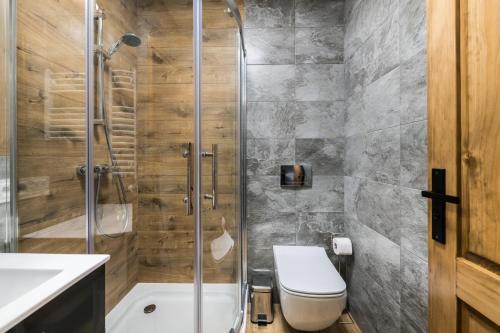 een badkamer met een douche, een toilet en een wastafel bij Janosówka in Czarna Góra